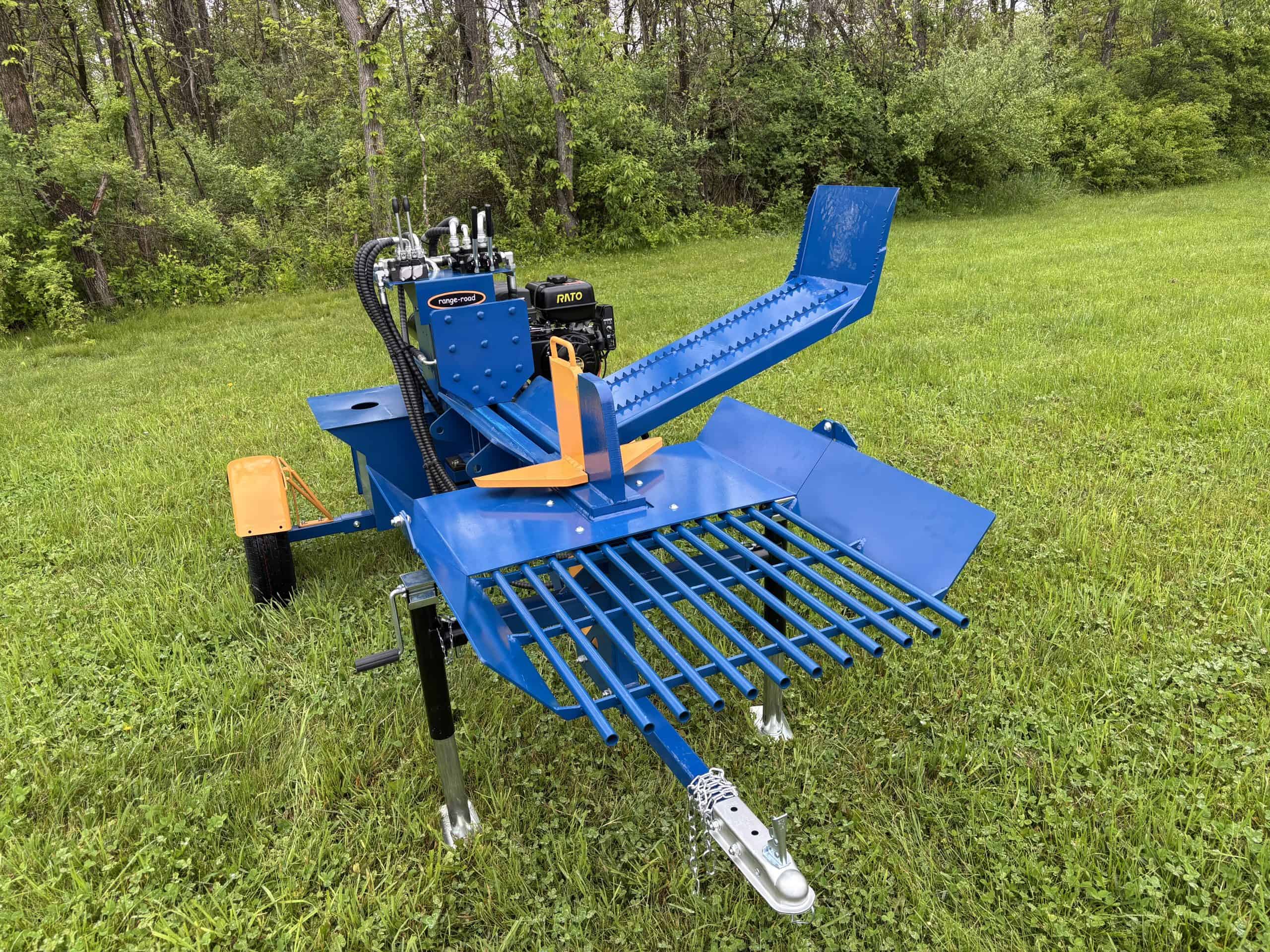 Blue heavy-duty tree mulcher on grassy field with trees in background.
